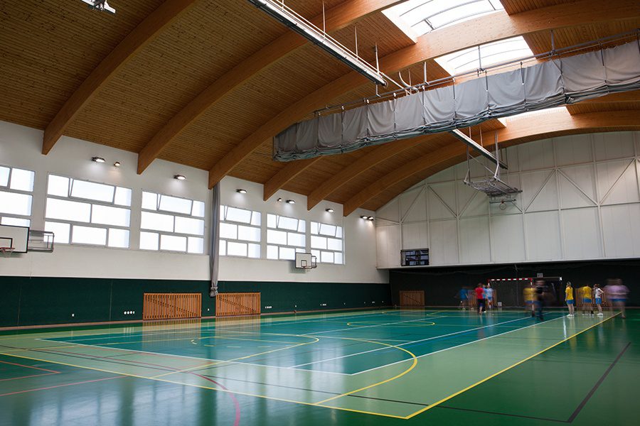 Sports Facility Insurance - Interior of a Modern Multifunctional Gymnasium with Young Athletes